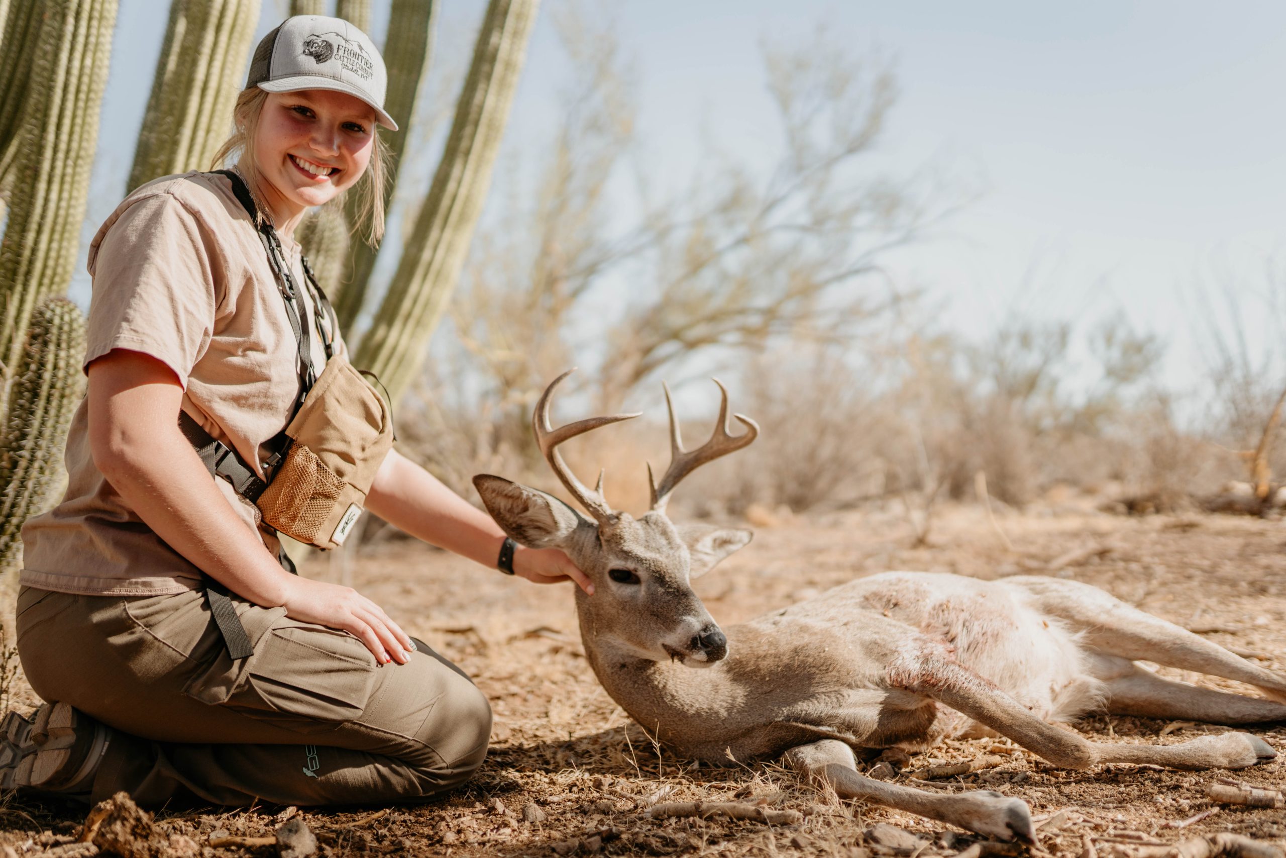 Female hunter with successful coues deer harvest in Mexican desert hunting expedition documented by Wildsmith