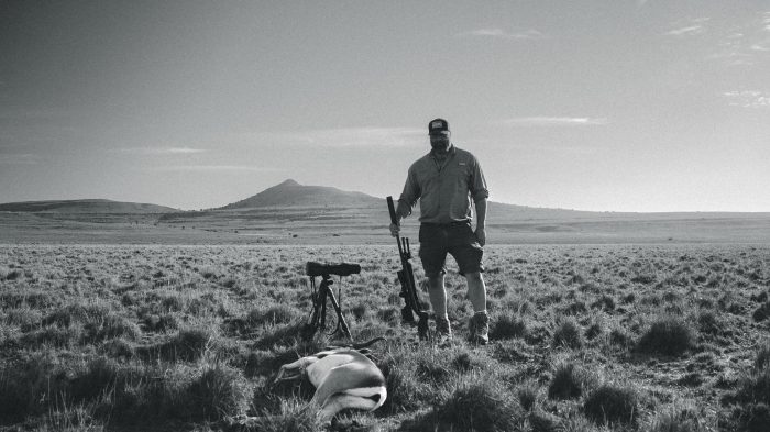 Hunter Greg with springbok trophy in vast Eastern Cape plains documented by Wildsmith for John X Safaris