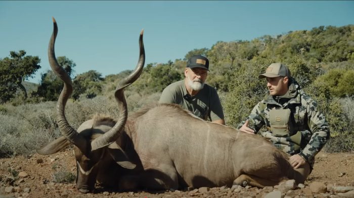 Hunter Calvery with magnificent kudu trophy and professional guide in Eastern Cape bushveld documented by Wildsmith for Tollies African Safaris